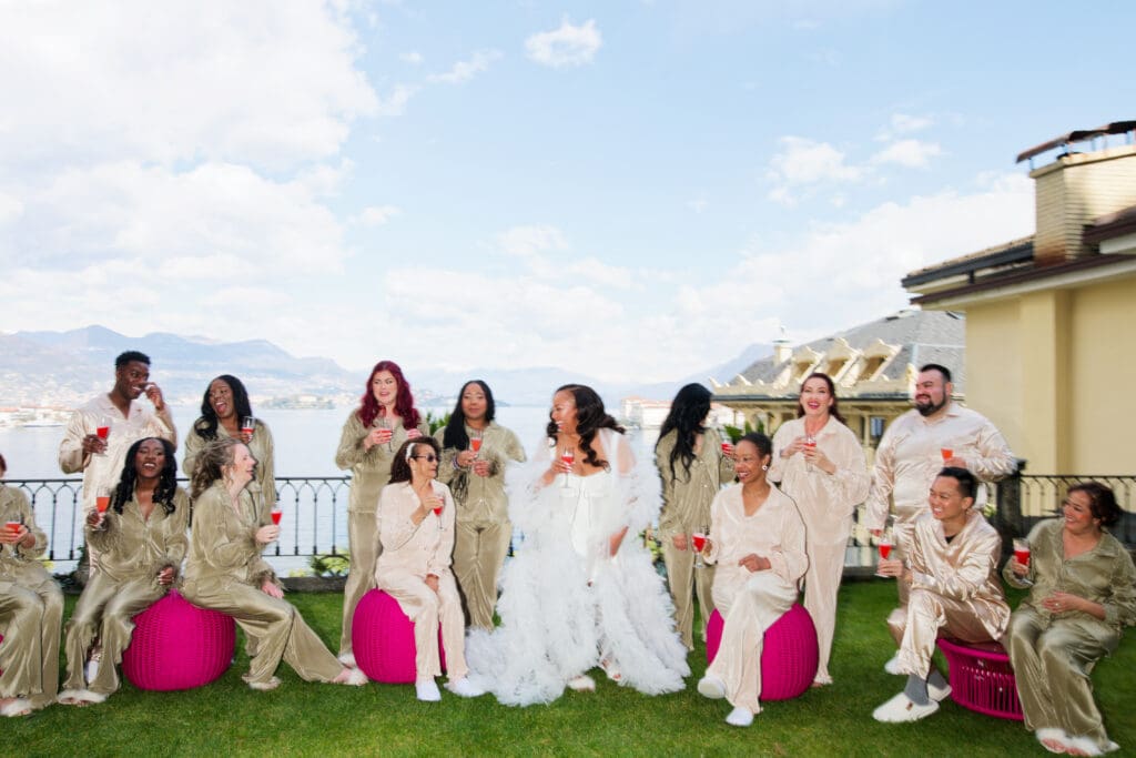 bride getting ready with bridal party laughing and celebrating with champagne
