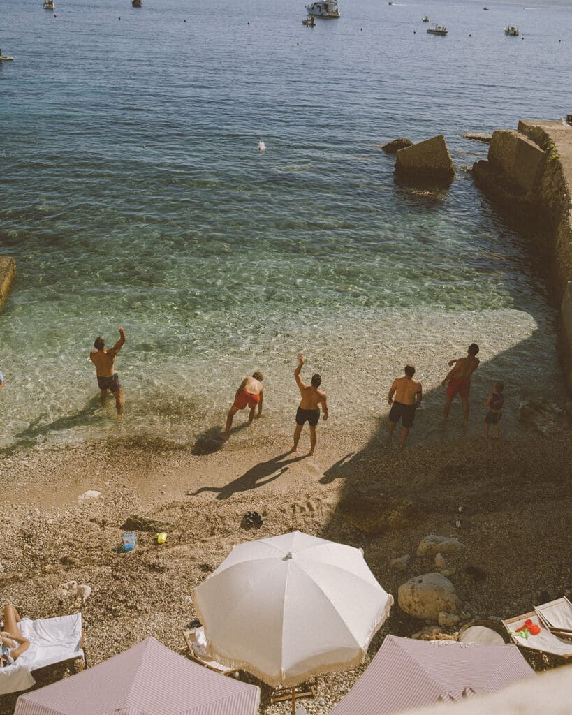 Guests enjoying the sea during a destination wedding weekend in Europe.