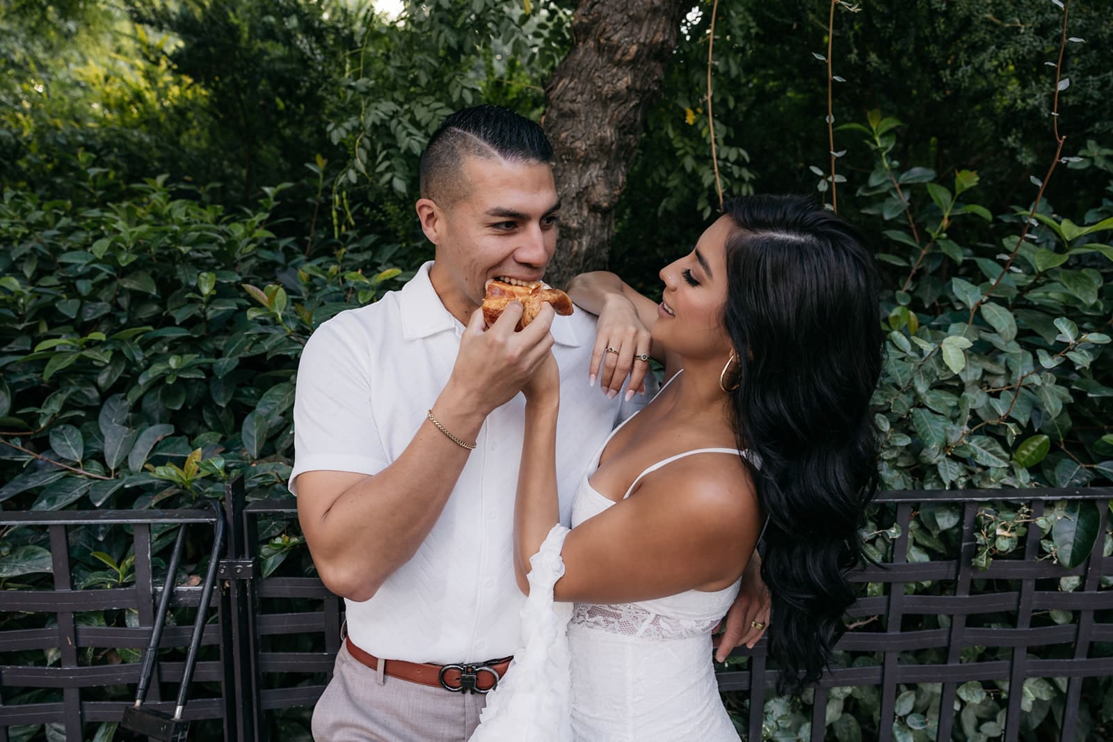 Couple enjoying local food together while exploring Europe before their destination wedding.